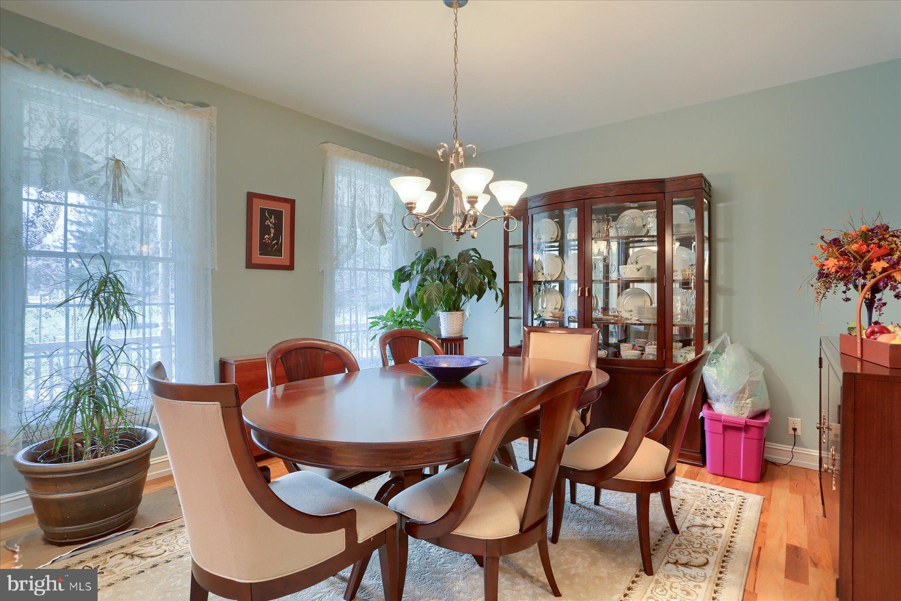 210 South Grantham Road Dillsburg, PA 17019 - Photo 11 of 56 a dining room with furniture a potted plant and a chandelier