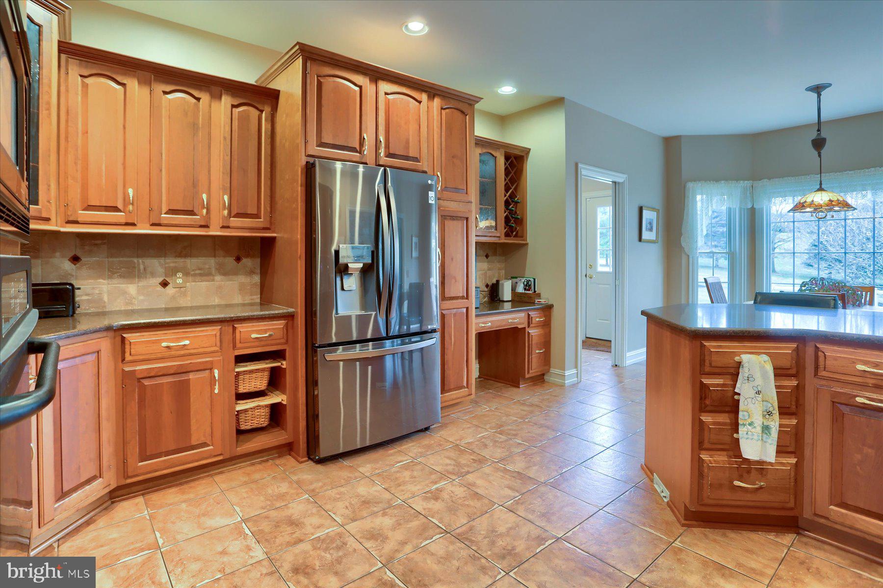210 South Grantham Road Dillsburg, PA 17019 - Photo 12 of 56 a kitchen with stainless steel appliances granite countertop a refrigerator and a stove top oven