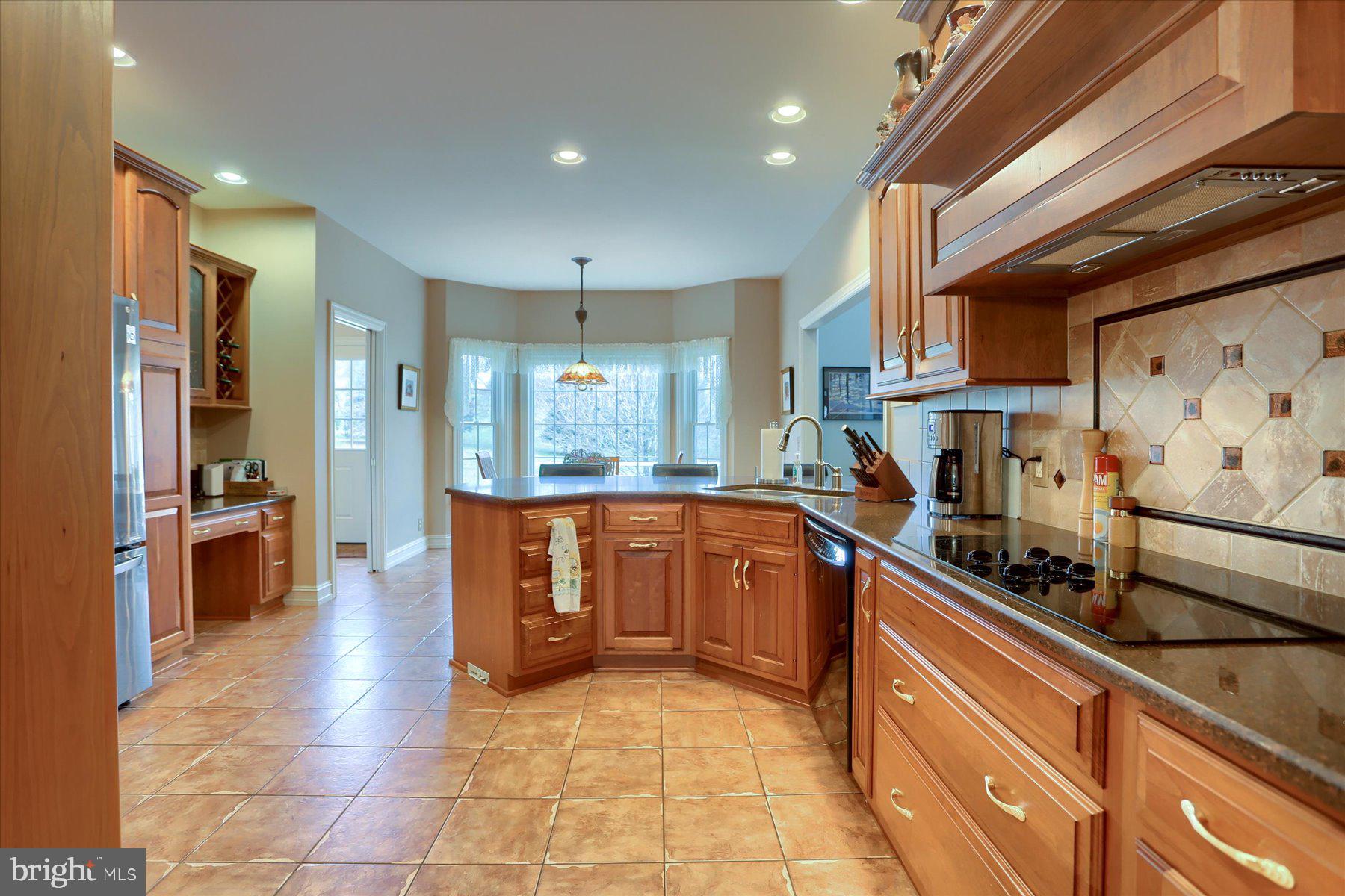 210 South Grantham Road Dillsburg, PA 17019 - Photo 13 of 56 a kitchen with stainless steel appliances granite countertop a refrigerator and a stove top oven