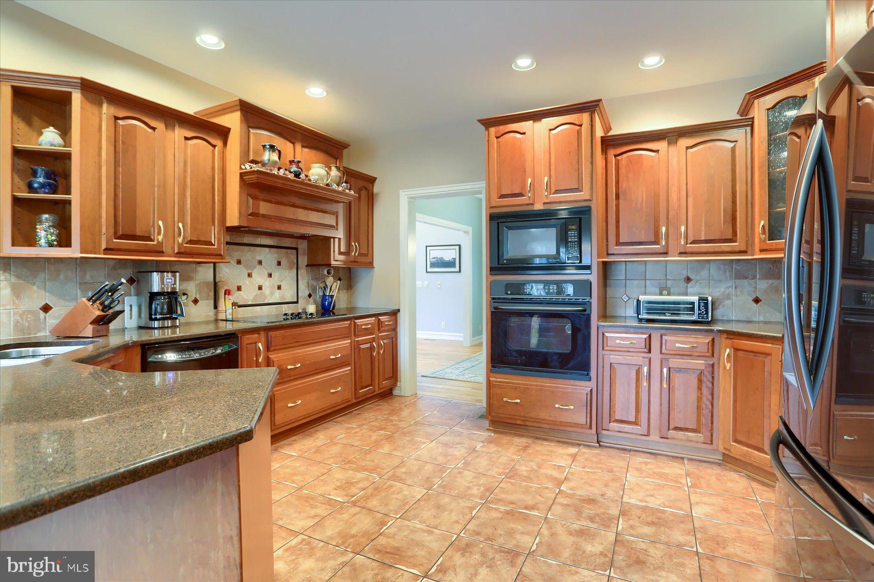 210 South Grantham Road Dillsburg, PA 17019 - Photo 14 of 56 a kitchen with stainless steel appliances granite countertop a refrigerator a stove top oven and sink