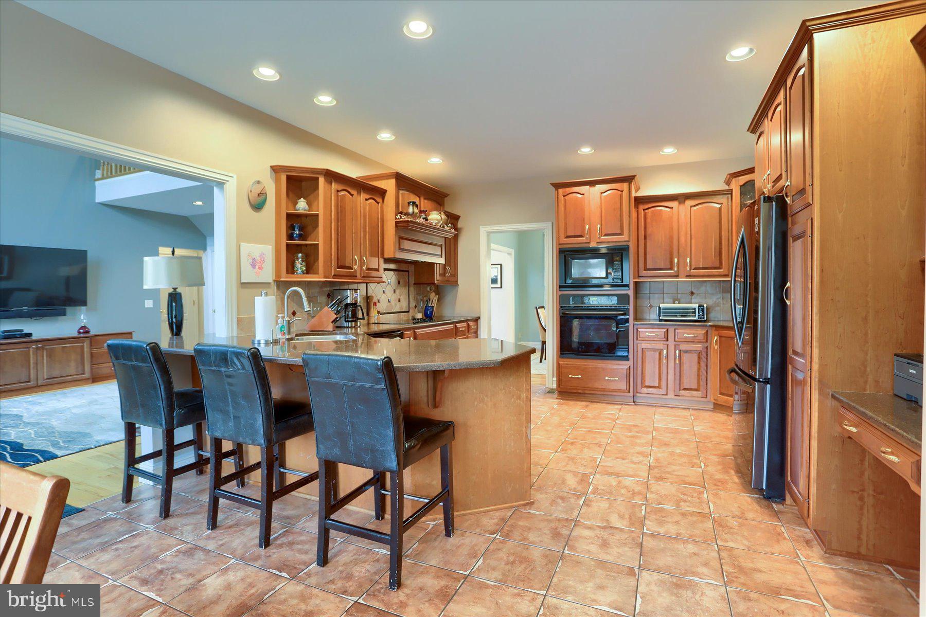 210 South Grantham Road Dillsburg, PA 17019 - Photo 15 of 56 a kitchen with stainless steel appliances kitchen island granite countertop a refrigerator and cabinets