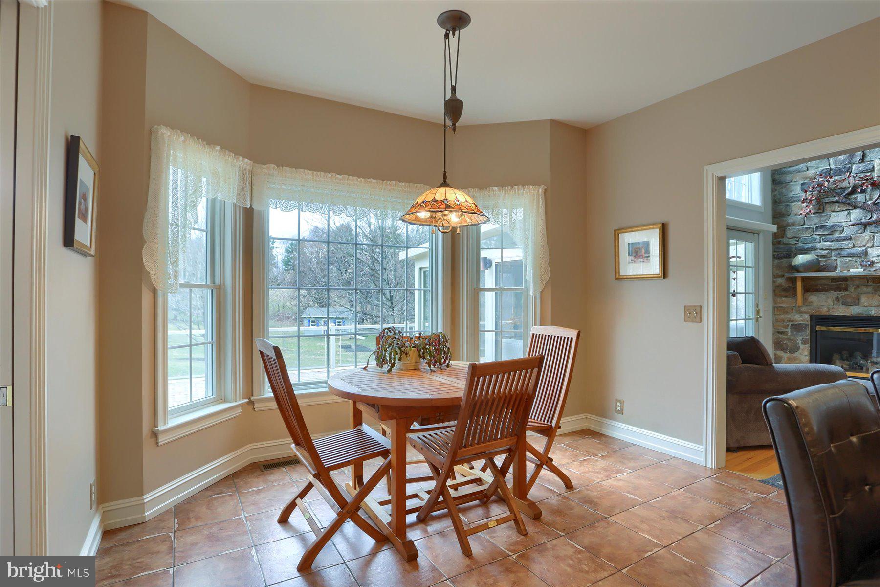 210 South Grantham Road Dillsburg, PA 17019 - Photo 16 of 56 a dining room with furniture large windows and a chandelier