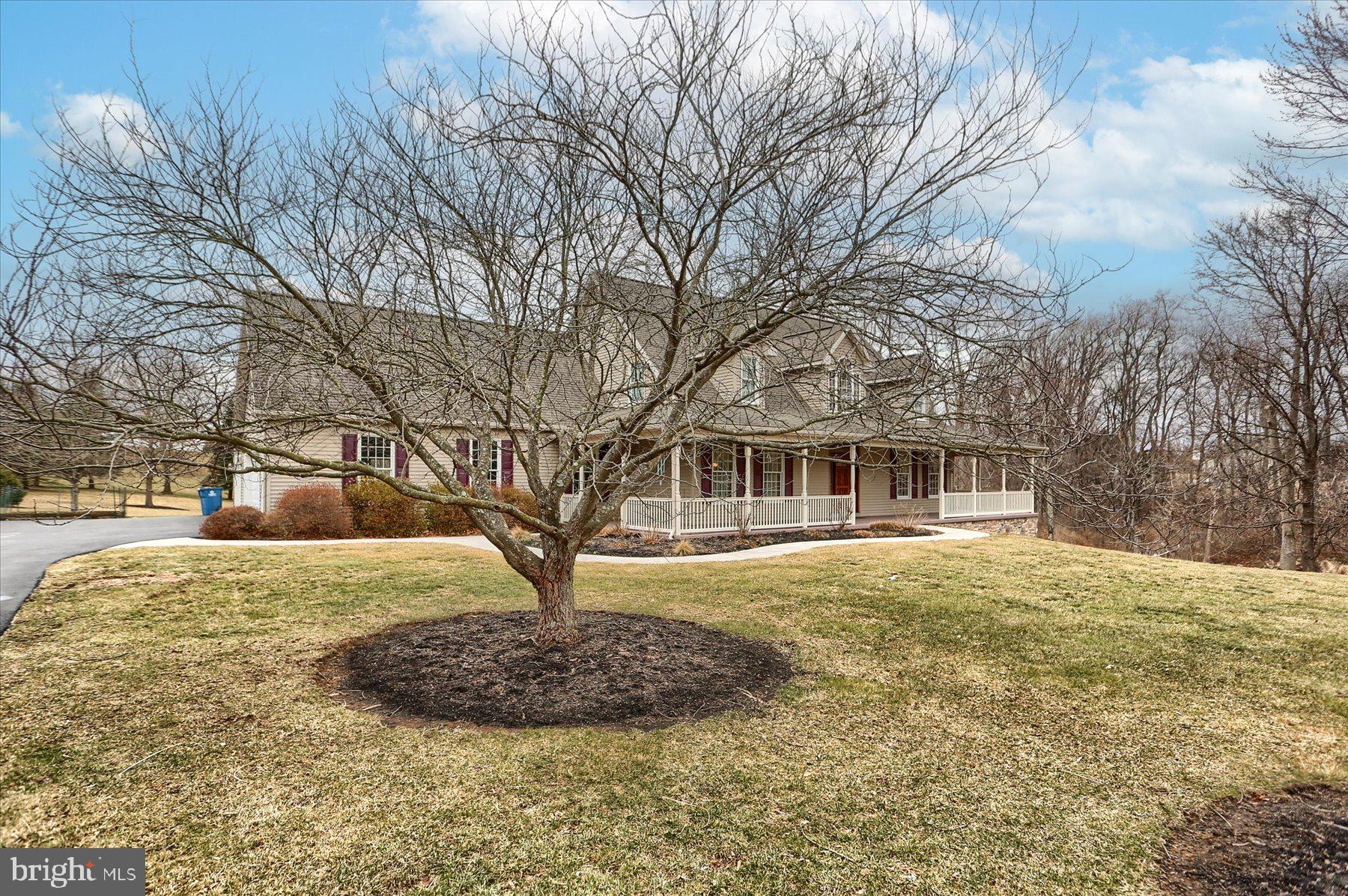 210 South Grantham Road Dillsburg, PA 17019 - Photo 2 of 56 a front view of a house with a yard and garage