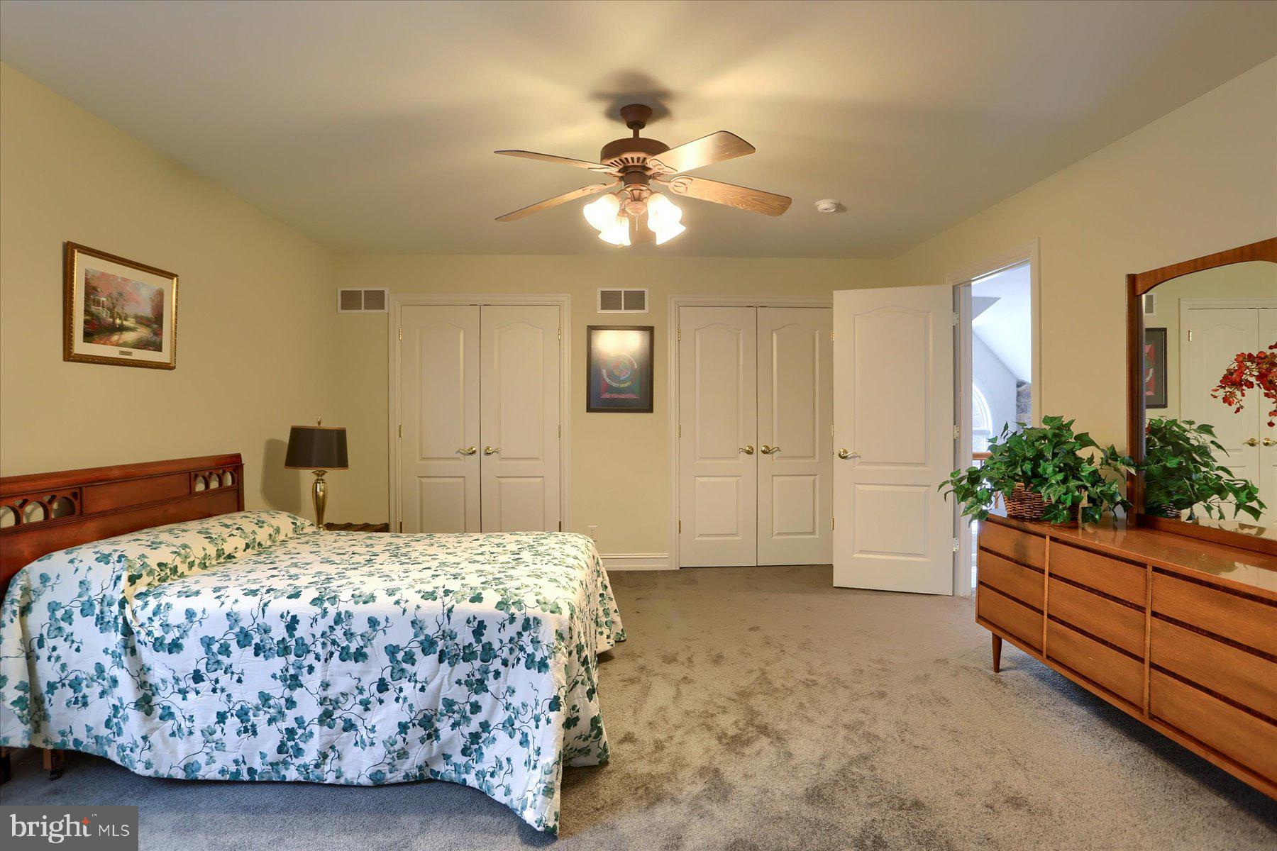 210 South Grantham Road Dillsburg, PA 17019 - Photo 42 of 56 a bedroom with a bed and a chandelier