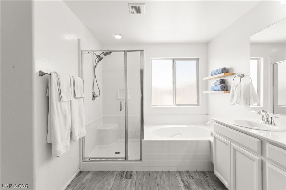 6435 Point Isabel Way Las Vegas, NV 89122 - Photo 29 of 57 A well-appointed bathroom offers both a spacious soaking tub and a walk-in shower for ultimate comfort.
