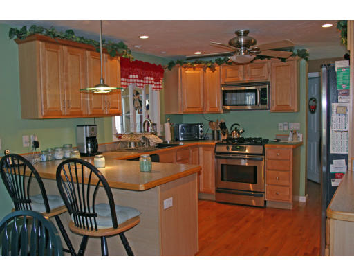 138 Gray Road Templeton, MA 01468 - Photo 14 of 29 a kitchen with stainless steel appliances a stove a sink a microwave and dining table