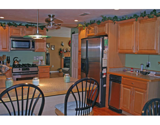 138 Gray Road Templeton, MA 01468 - Photo 15 of 29 a kitchen with stainless steel appliances a dining table and chairs