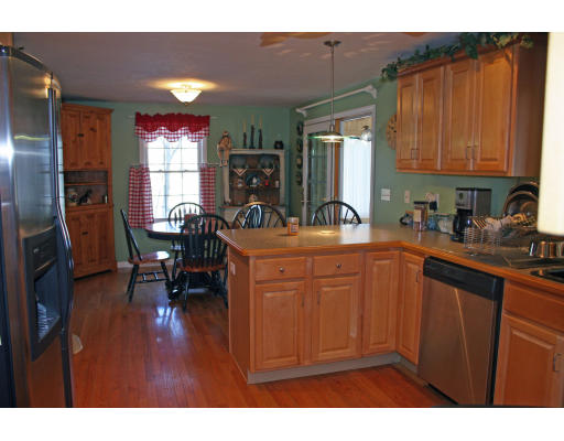 138 Gray Road Templeton, MA 01468 - Photo 16 of 29 a kitchen with sink refrigerator dining table and chairs