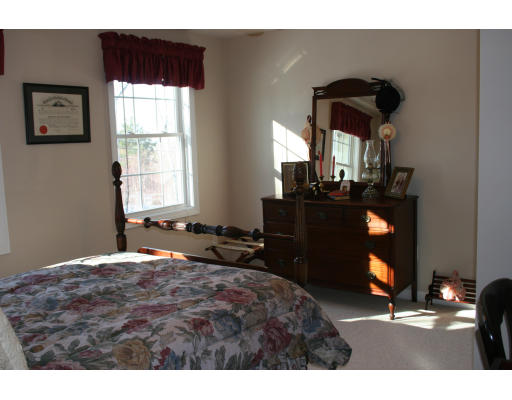 138 Gray Road Templeton, MA 01468 - Photo 25 of 29 a bedroom with a bed and a chandelier