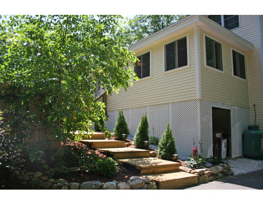 138 Gray Road Templeton, MA 01468 - Photo 7 of 29 a view of a white house with a yard and plants