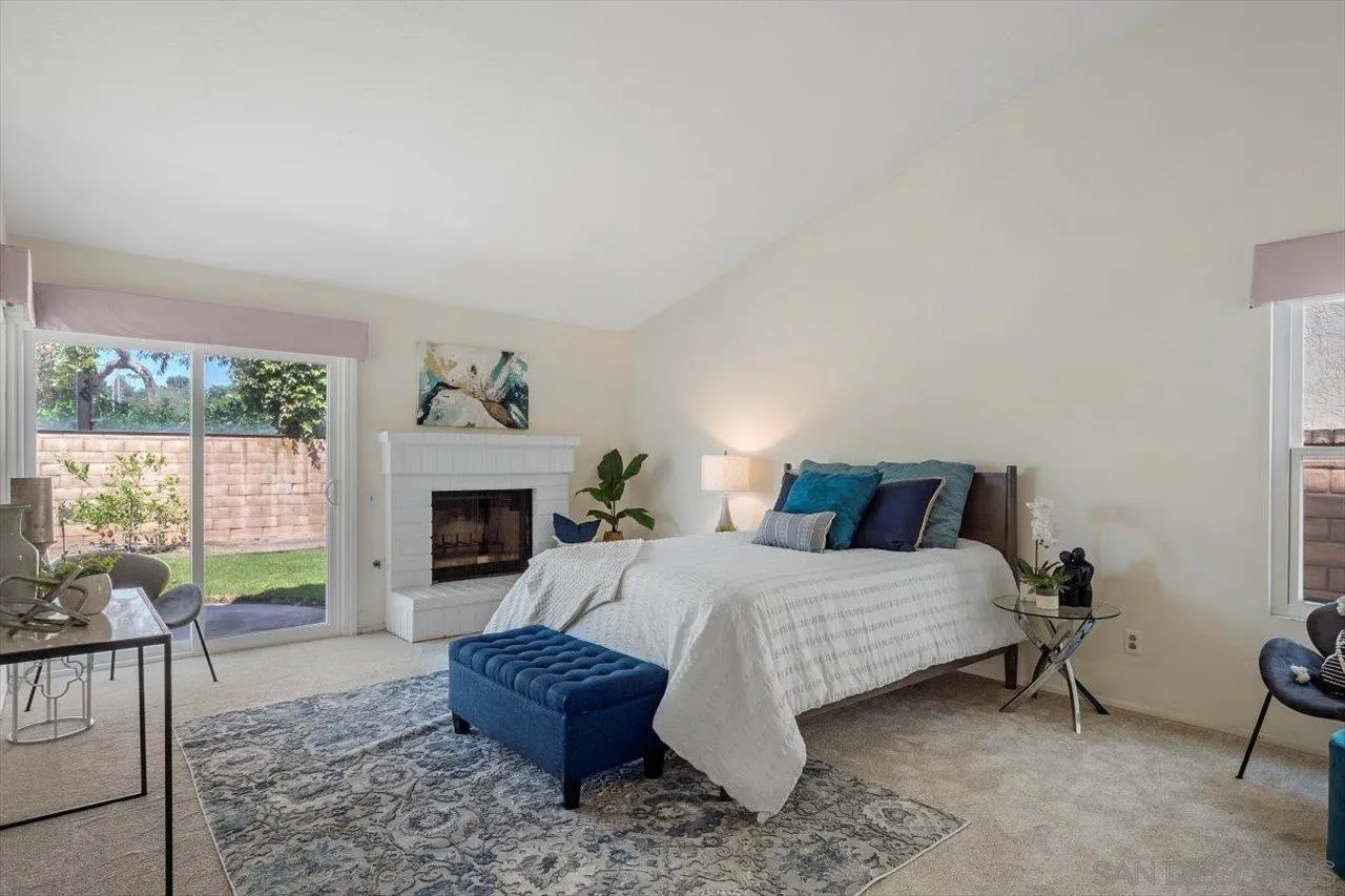 3355 Lower Ridge Road San Diego, CA 92130 - Photo 22 of 31 a living room with furniture a fireplace and a potted plant