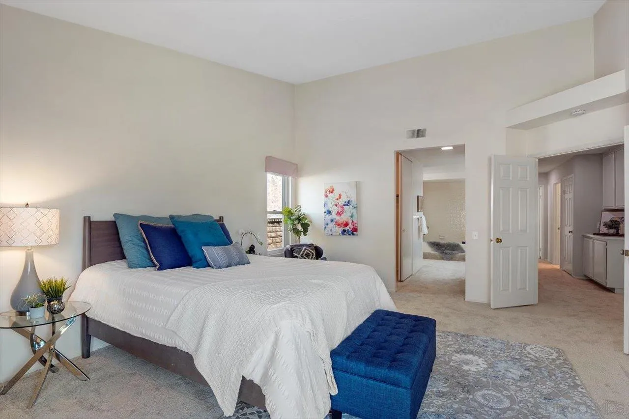 3355 Lower Ridge Road San Diego, CA 92130 - Photo 23 of 31 a bedroom with a bed and a large mirror