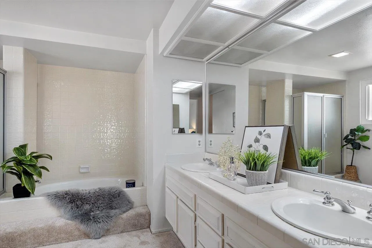 3355 Lower Ridge Road San Diego, CA 92130 - Photo 25 of 31 a bathroom with a granite countertop sink and a mirror