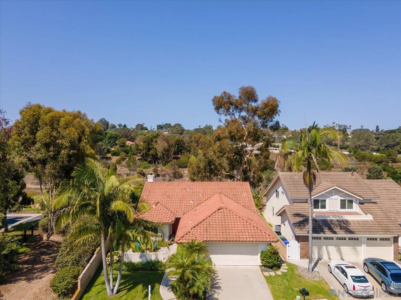 3355 Lower Ridge Road San Diego, CA 92130 - Photo 27 of 31 a view of a house with a yard and a pond