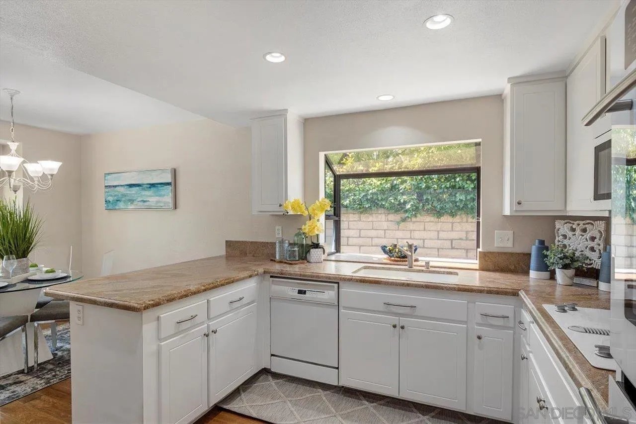 3355 Lower Ridge Road San Diego, CA 92130 - Photo 5 of 31 a kitchen with a sink window and cabinets