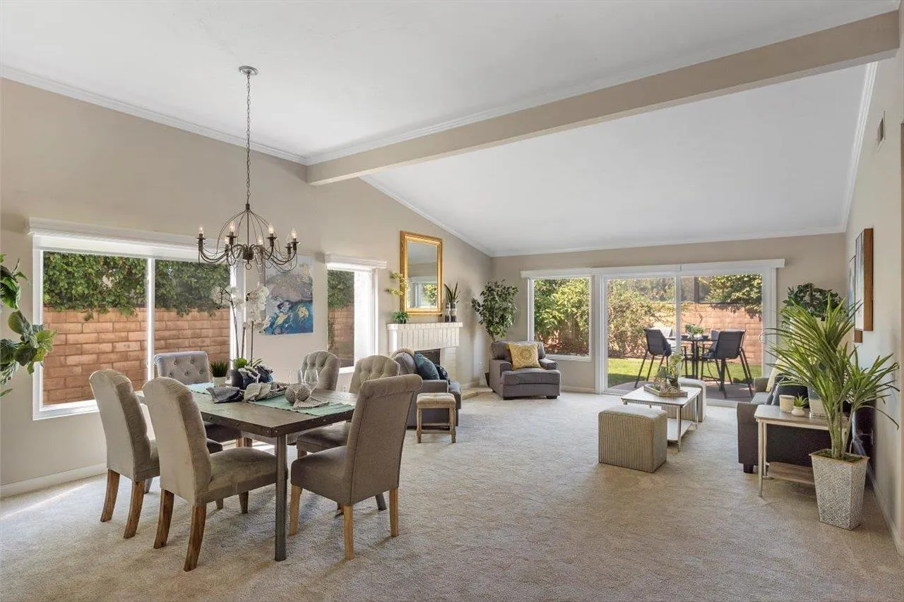 3355 Lower Ridge Road San Diego, CA 92130 - Photo 9 of 31 a living room with furniture potted plant floor to ceiling windows and a chandelier