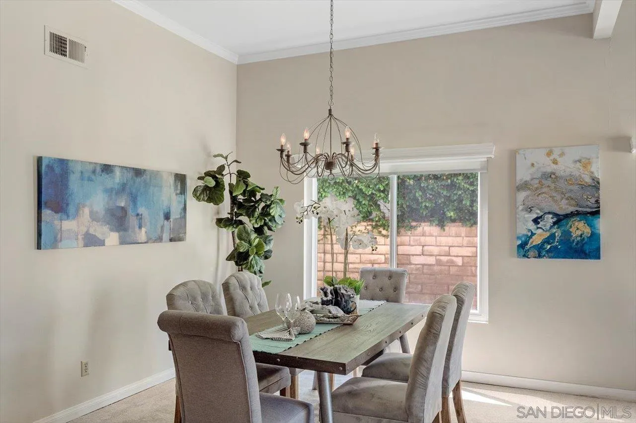 3355 Lower Ridge Road San Diego, CA 92130 - Photo 10 of 31 a view of a dining room with furniture wooden floor and a chandelier