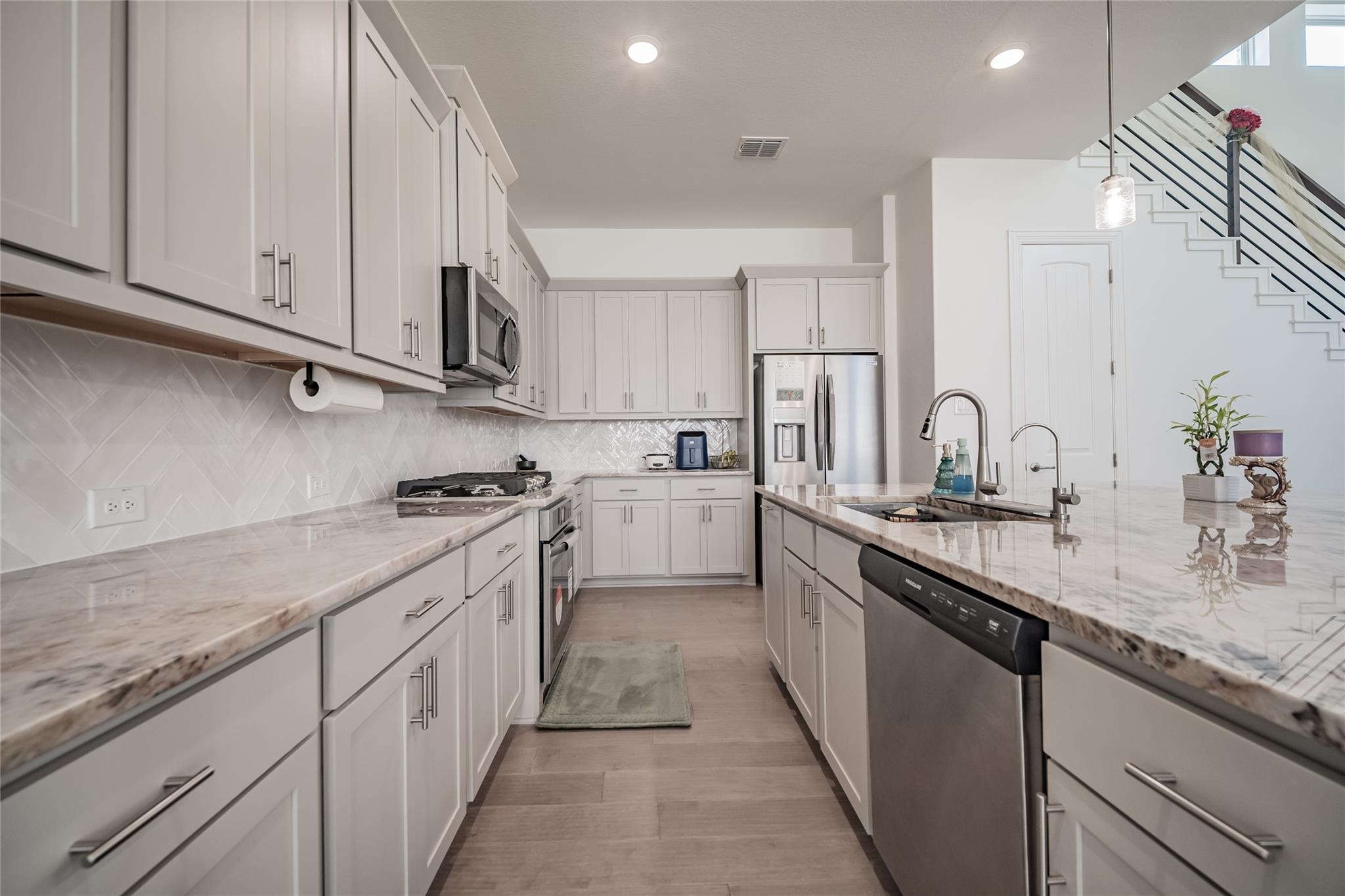3049 Sage Ranch Drive Leander, TX 78641 - Photo 20 of 23 Culinary aspirations come alive in this kitchen, featuring luxurious countertops and modern appliances.