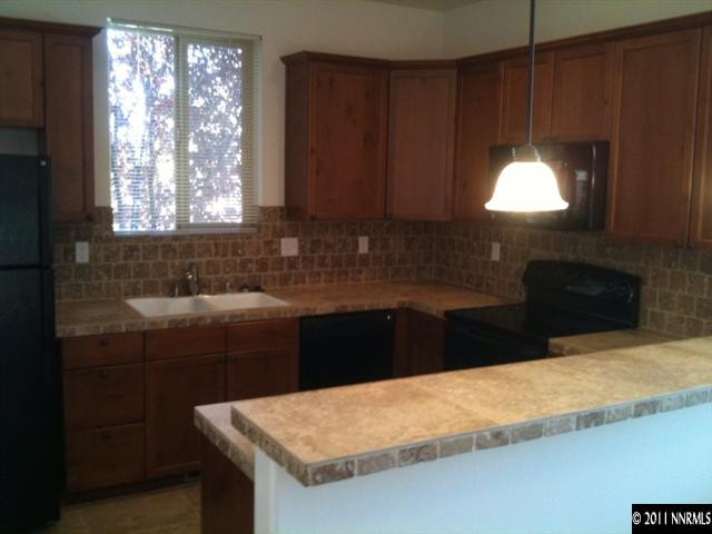 3677 Warren Way, Unit B Reno, NV 89509 - Photo 3 of 6 a kitchen with a sink a window and cabinets