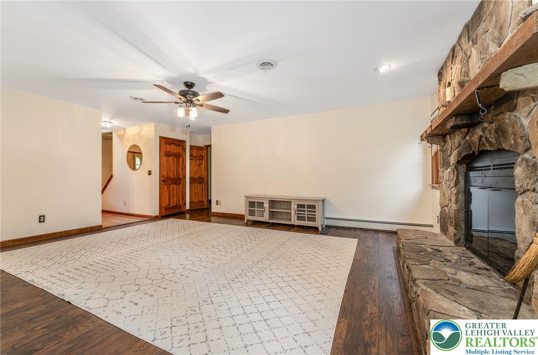 465 Raubsville Road Easton, PA 18042 - Photo 24 of 60 A spacious living room welcomes with warm Laminate flooring and a commanding stone fireplace.