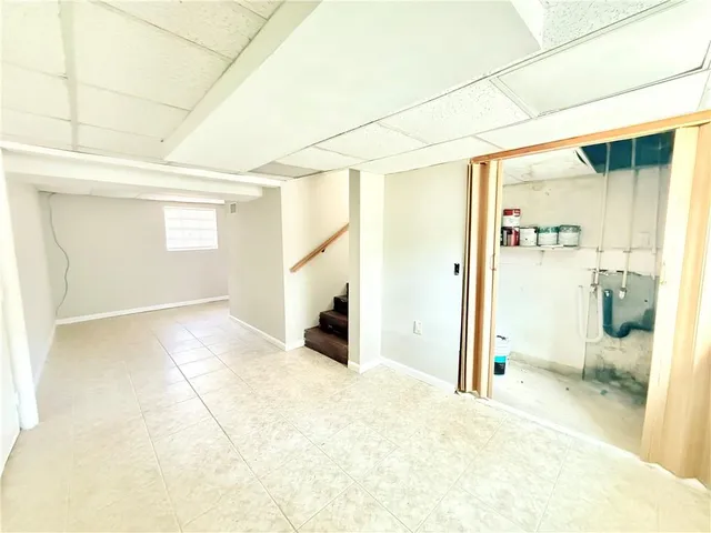 a view of a livingroom with wooden floor and a refrigerator