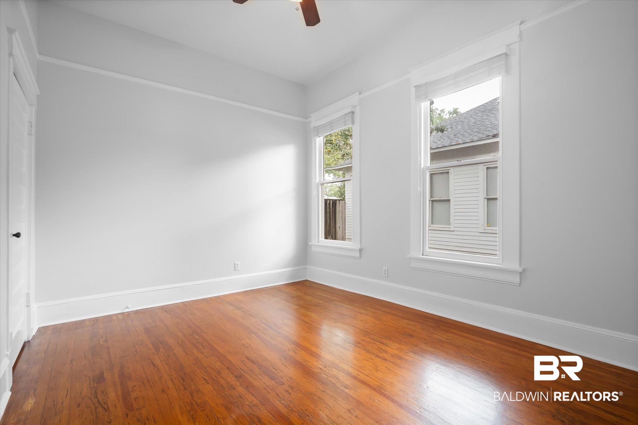 14 South Monterey Street Mobile, AL 36604 - Photo 16 of 41 Empty room with hardwood / wood-style floors and ceiling fan