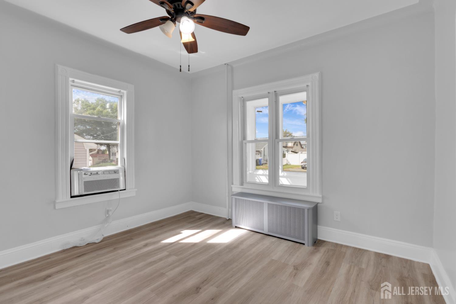 36 3rd Avenue, Unit B Port Reading, NJ 07064 - Photo 12 of 21 a view of an empty room with wooden floor and a window
