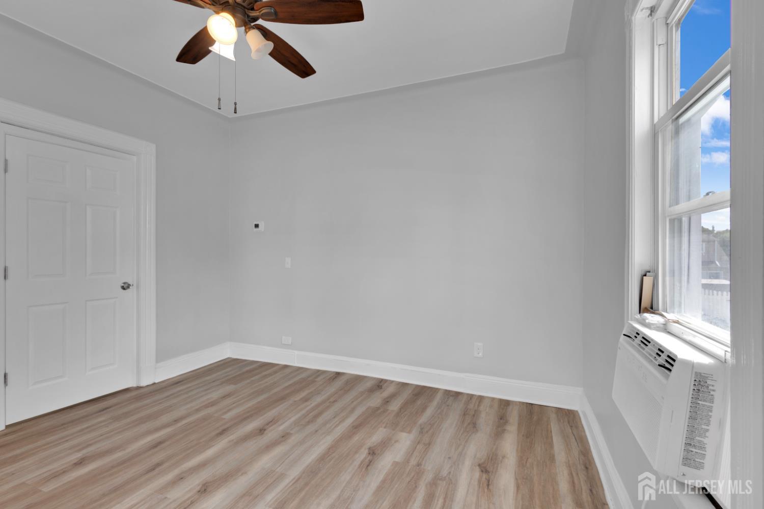 36 3rd Avenue, Unit B Port Reading, NJ 07064 - Photo 13 of 21 wooden floor in an empty room with a window