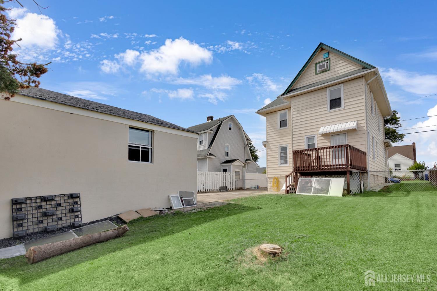 36 3rd Avenue, Unit B Port Reading, NJ 07064 - Photo 19 of 21 a front view of a house with a garden and yard