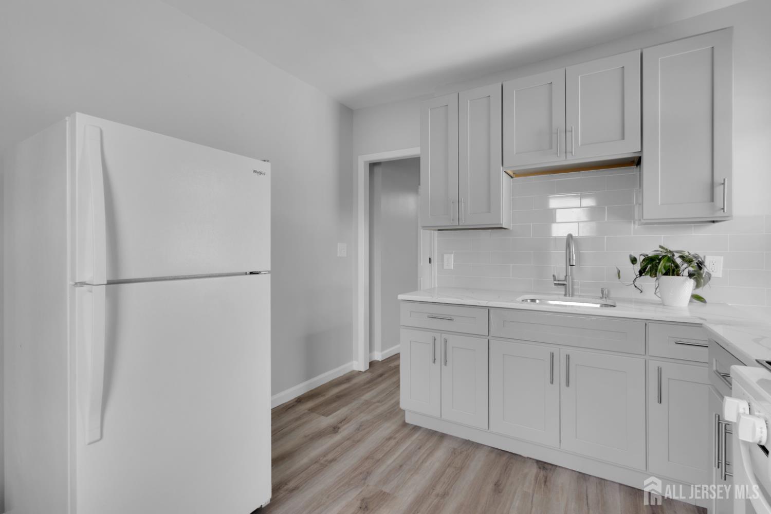 36 3rd Avenue, Unit B Port Reading, NJ 07064 - Photo 2 of 21 a kitchen with white cabinets and white appliances