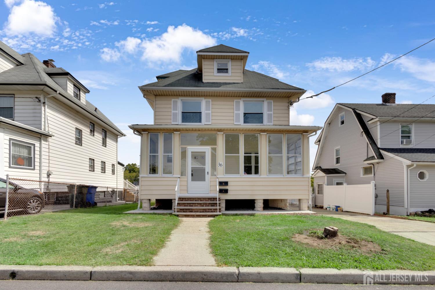 36 3rd Avenue, Unit B Port Reading, NJ 07064 - Photo 3 of 21 a front view of a house with a yard
