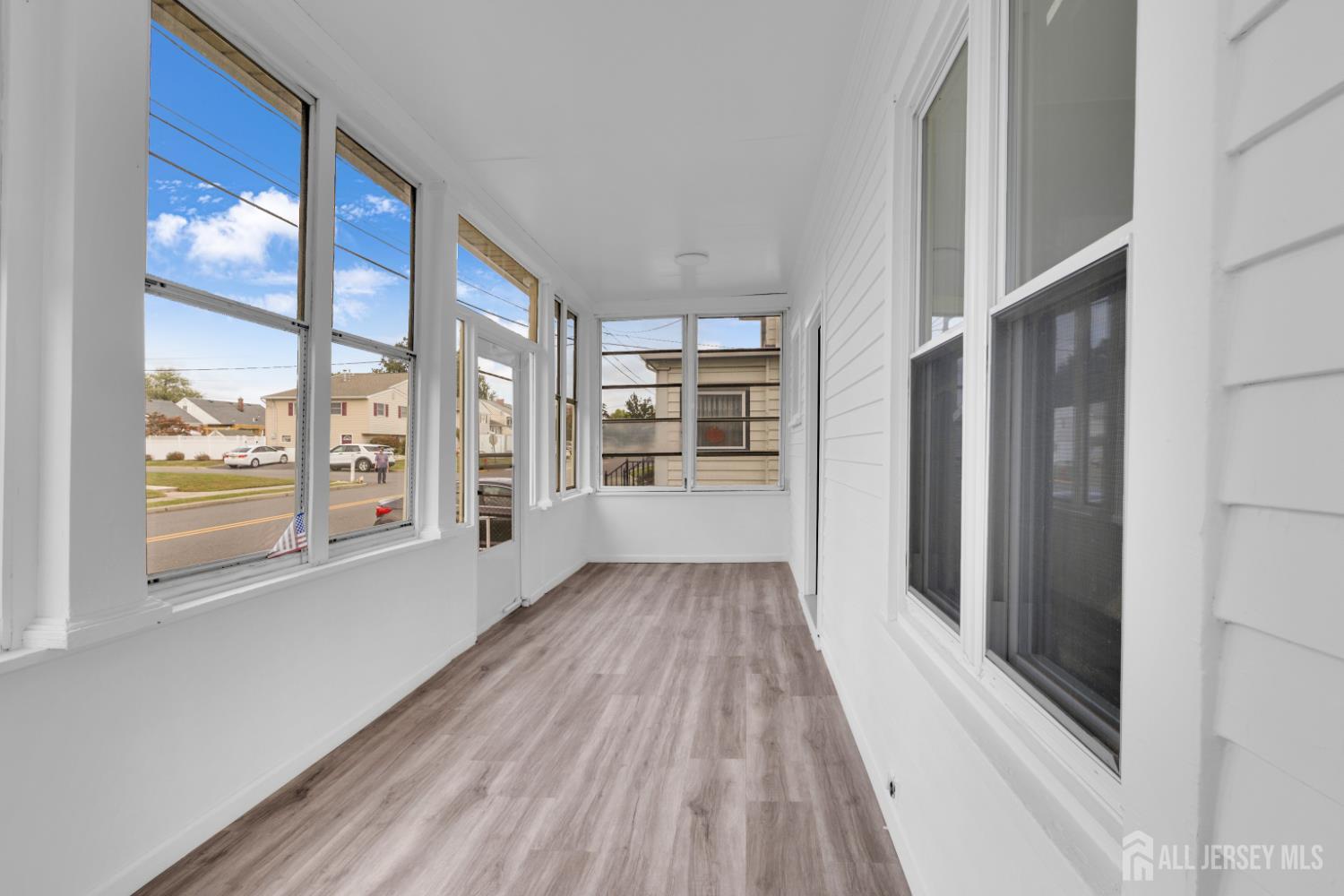36 3rd Avenue, Unit B Port Reading, NJ 07064 - Photo 4 of 21 a view of an empty room with wooden floor and a window