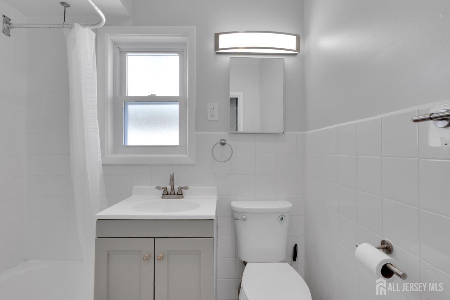 36 3rd Avenue, Unit B Port Reading, NJ 07064 - Photo 5 of 21 a bathroom with a sink a toilet and shower