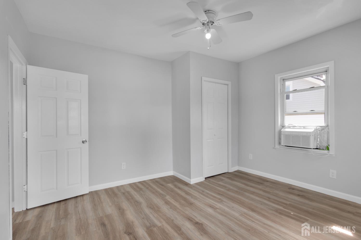 36 3rd Avenue, Unit B Port Reading, NJ 07064 - Photo 6 of 21 a view of empty room with wooden floor and fan