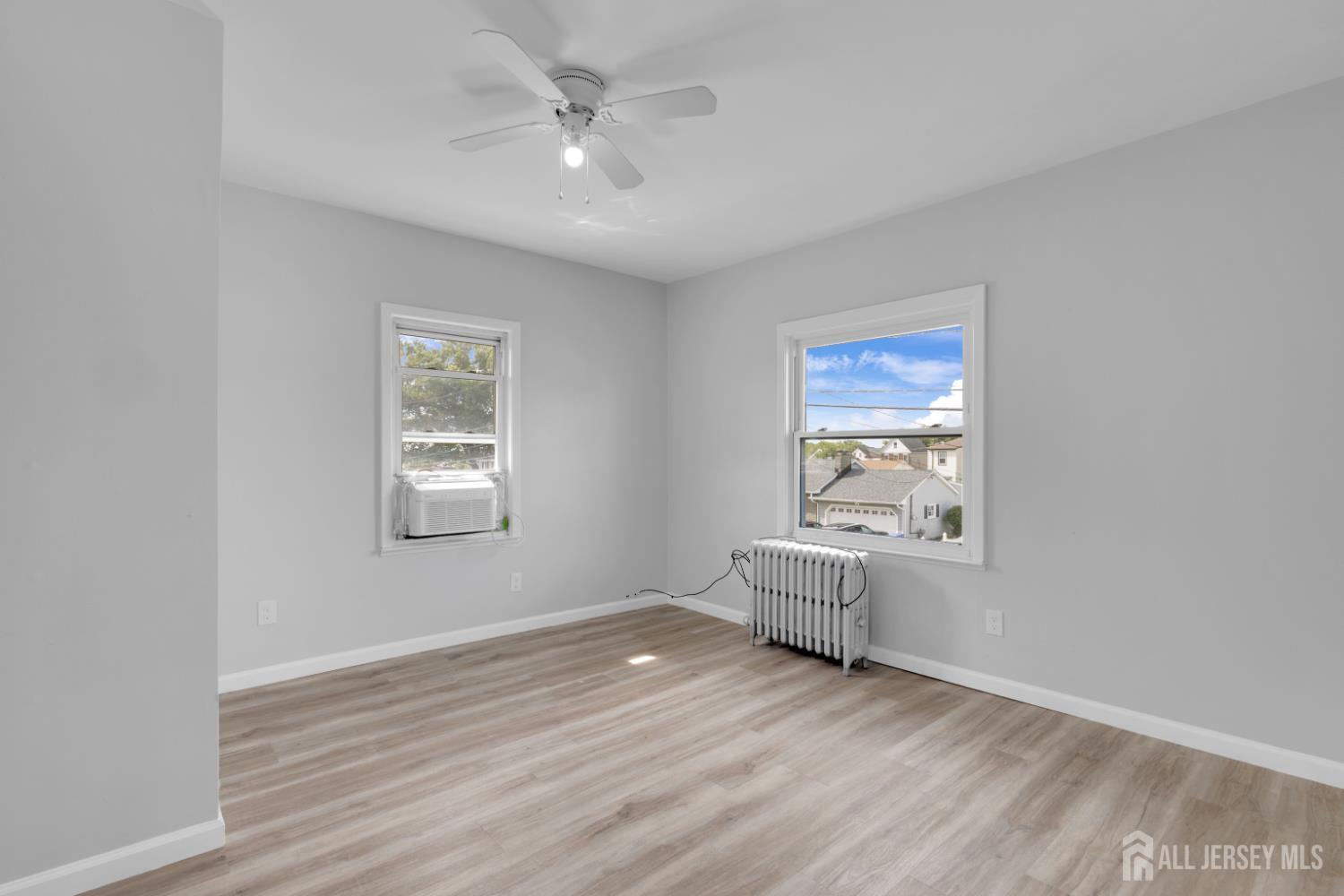 36 3rd Avenue, Unit B Port Reading, NJ 07064 - Photo 7 of 21 wooden floor in an empty room with a window