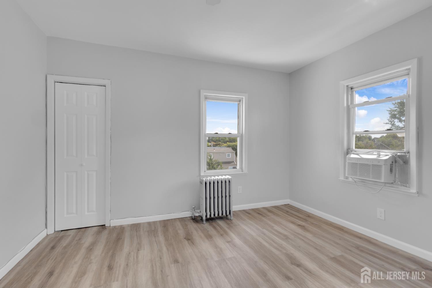 36 3rd Avenue, Unit B Port Reading, NJ 07064 - Photo 8 of 21 a view of an empty room with wooden floor and a window