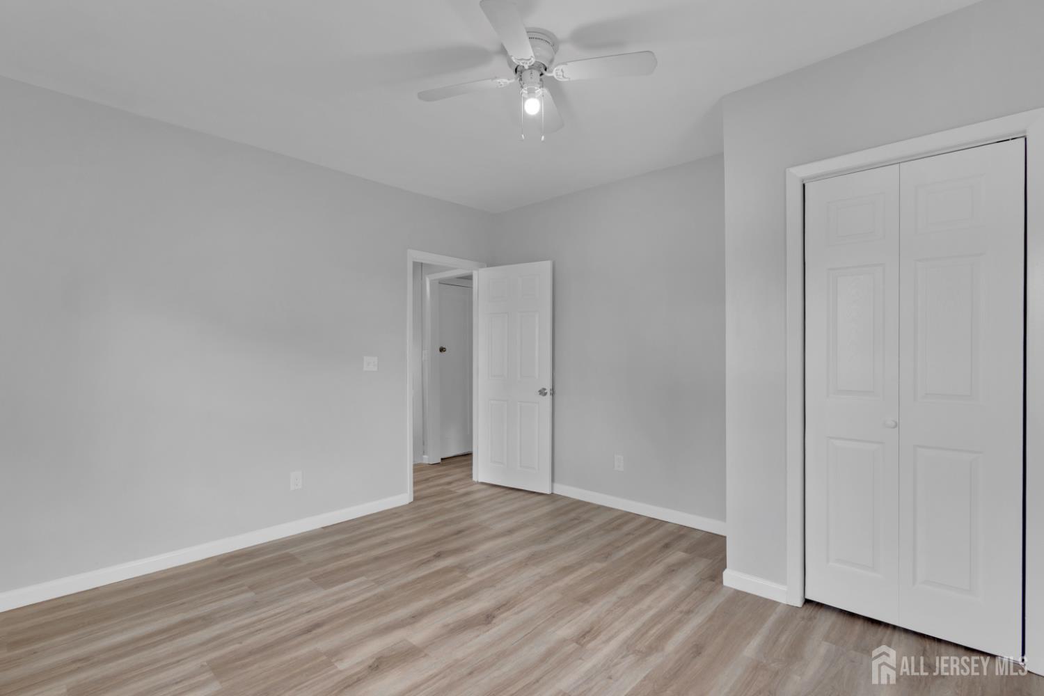 36 3rd Avenue, Unit B Port Reading, NJ 07064 - Photo 9 of 21 a view of an empty room with wooden floor