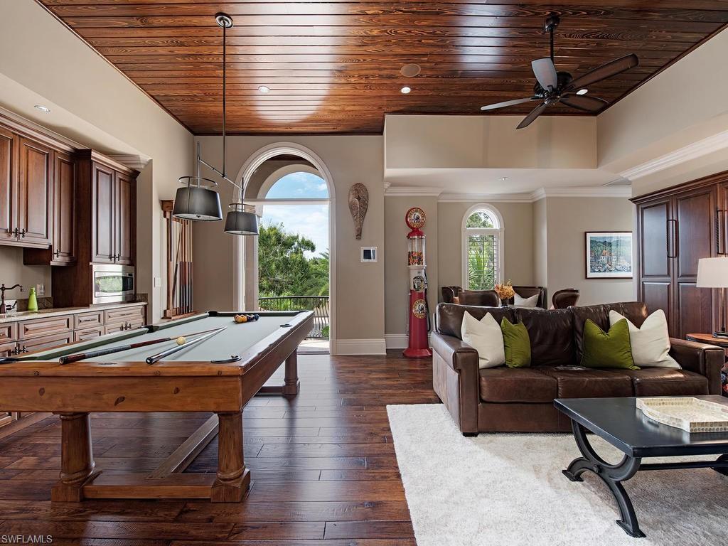 515 Riviera Drive Naples, FL 34103 - Photo 18 of 35 a living room with furniture wooden floor and a table
