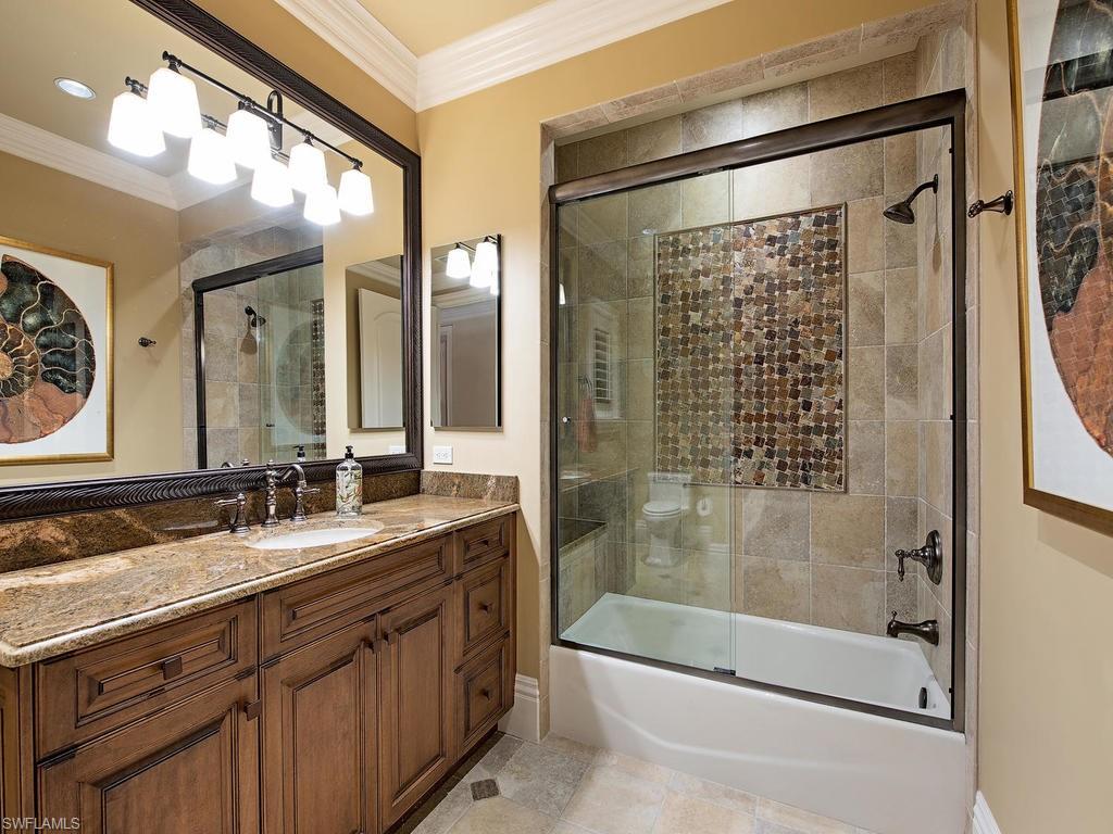 515 Riviera Drive Naples, FL 34103 - Photo 26 of 35 a bathroom with a double vanity sink mirror and shower