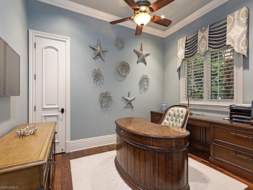 515 Riviera Drive Naples, FL 34103 - Photo 27 of 35 a living room with furniture and a fireplace