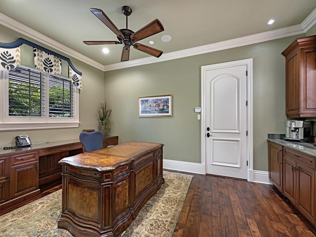 515 Riviera Drive Naples, FL 34103 - Photo 29 of 35 a room with kitchen island stainless steel appliances sink cabinets and window