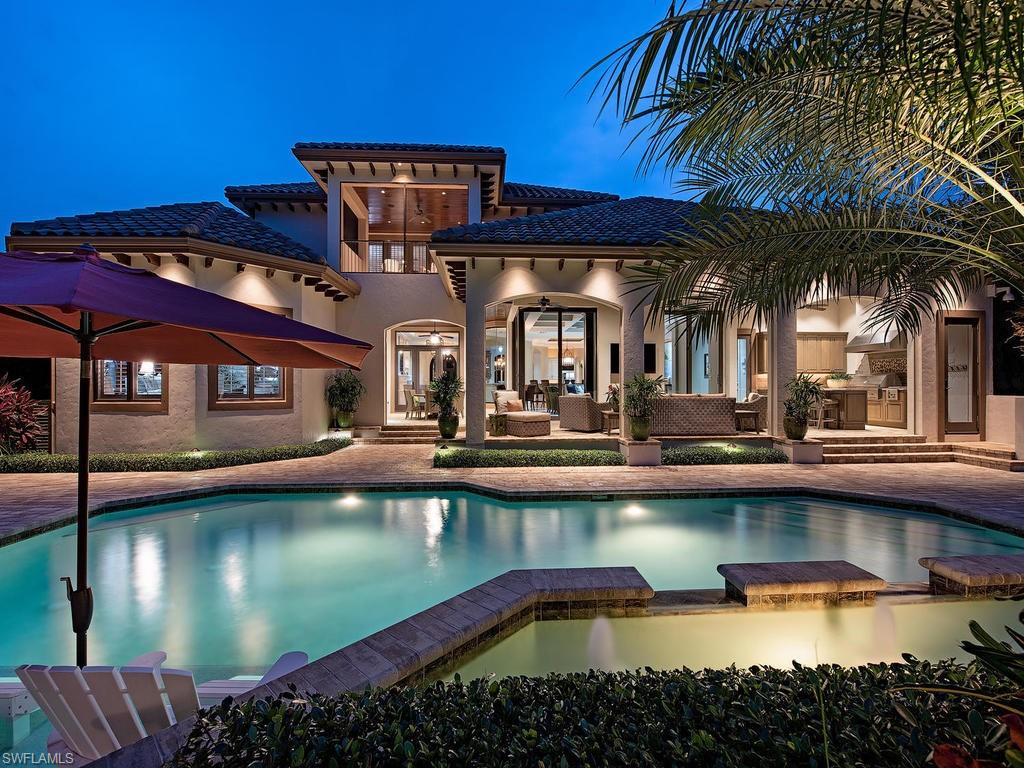 515 Riviera Drive Naples, FL 34103 - Photo 3 of 35 a view of a house with pool and chairs