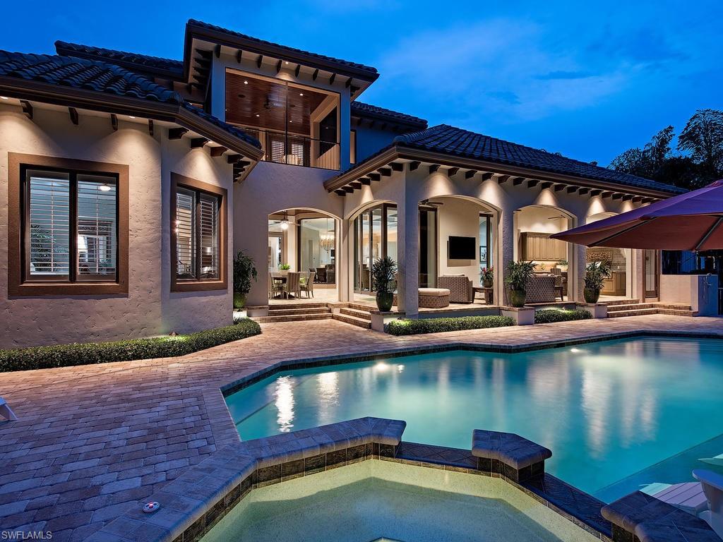 515 Riviera Drive Naples, FL 34103 - Photo 33 of 35 a view of a patio with swimming pool table and chairs