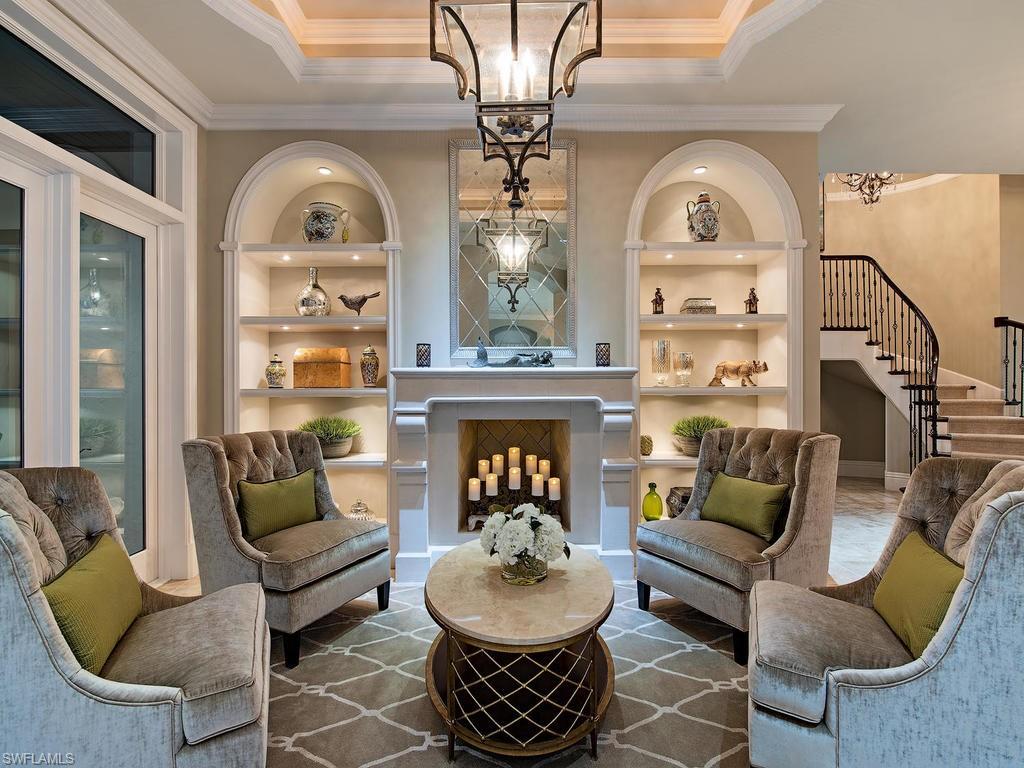515 Riviera Drive Naples, FL 34103 - Photo 6 of 35 a living room with furniture a fireplace and a chandelier