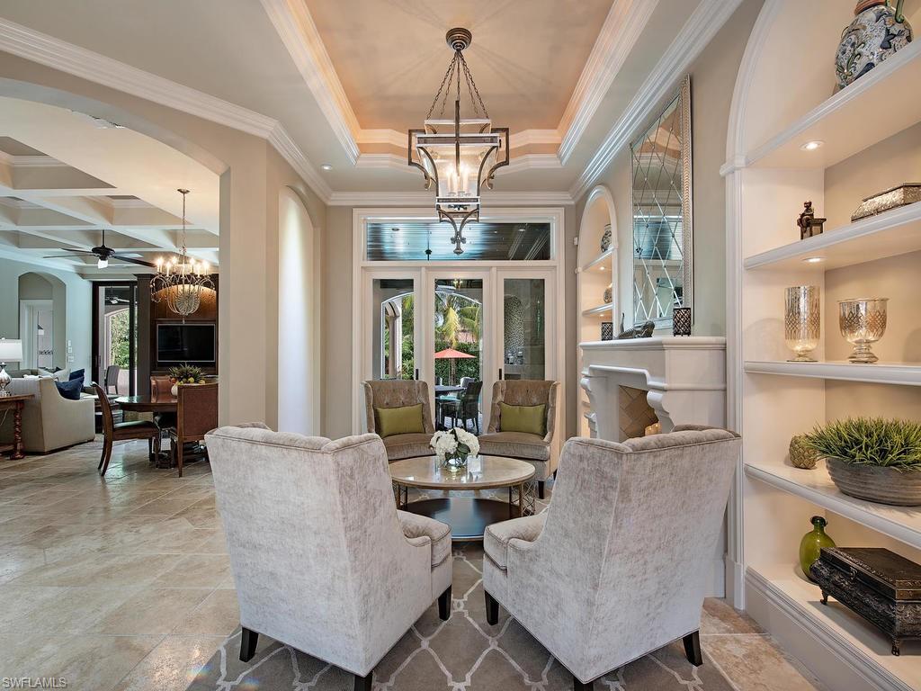 515 Riviera Drive Naples, FL 34103 - Photo 7 of 35 a living room with fireplace furniture and a chandelier