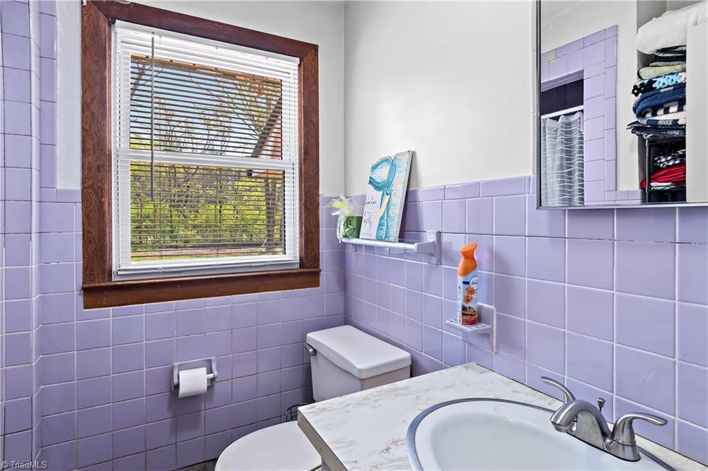 844 Rainbow Road Advance, NC 27006 - Photo 18 of 43 Third bath trimmed in tile with single shower and single vanity with storage.