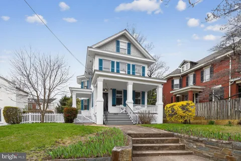 a front view of a residential apartment building with a yard