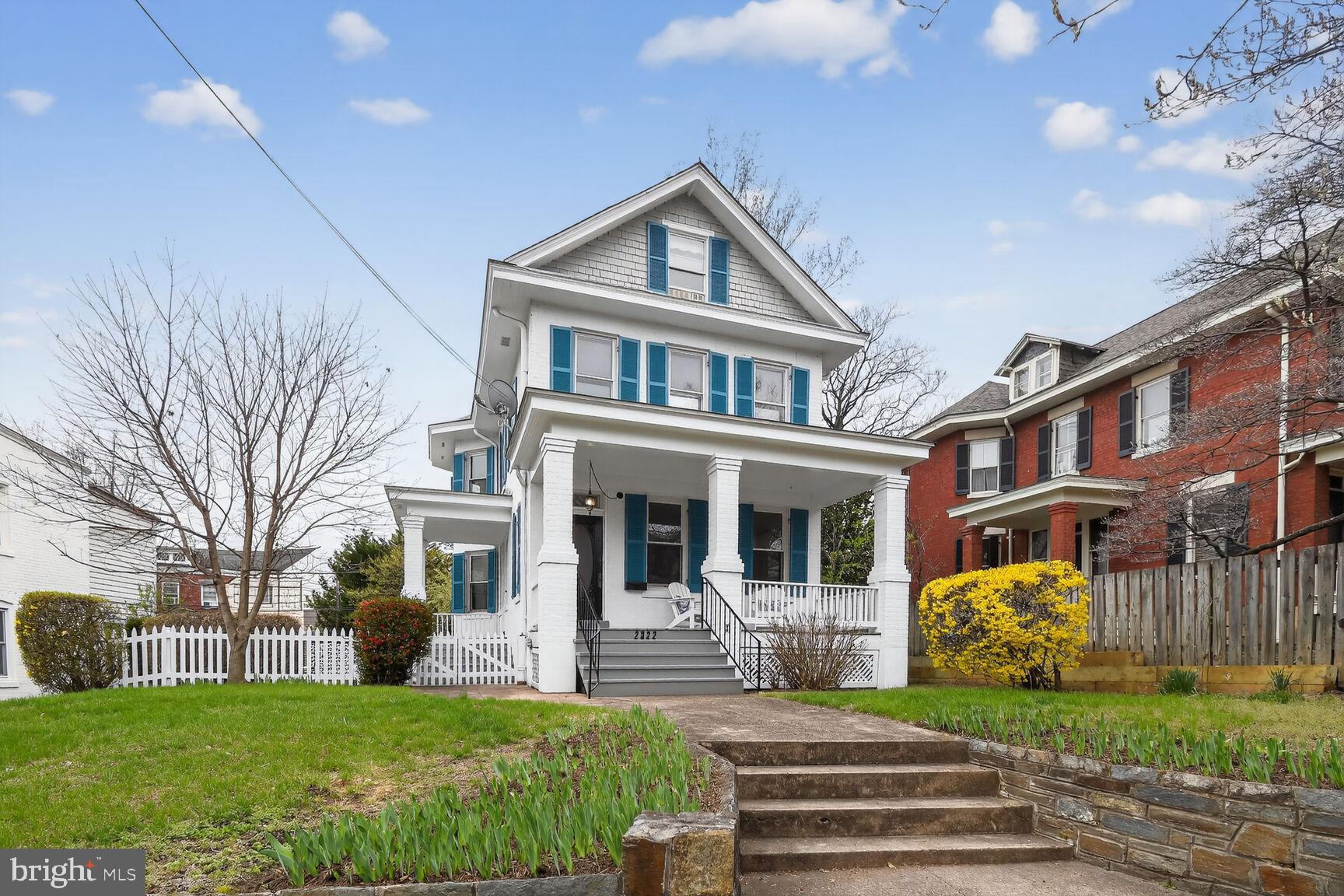 a front view of a residential apartment building with a yard