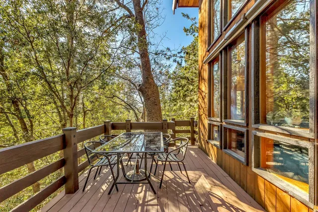 a living room with a large window and a bed