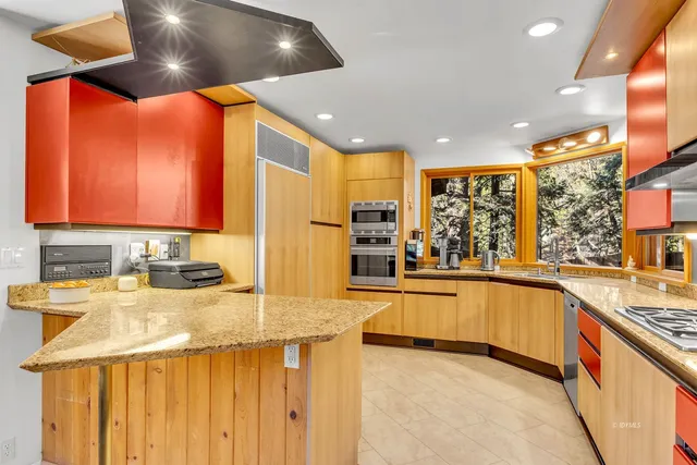 a patio with a table and chairs under an umbrella